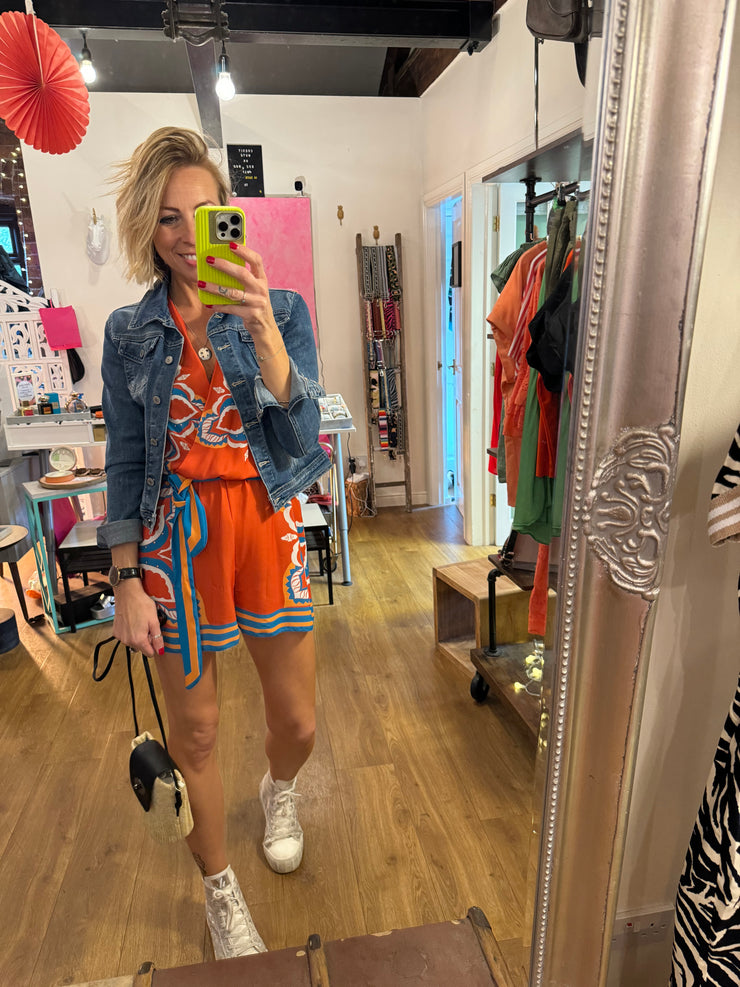 BORDER PRINT PLAYSUIT IN ORANGE